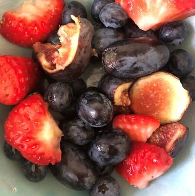 Bowl of figs, strawberries and grapes